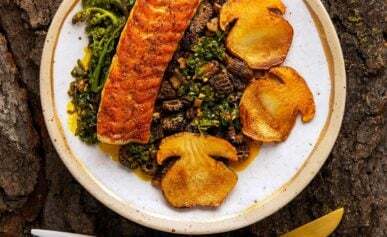 Seared lake trout, porcini and morels on a plate.