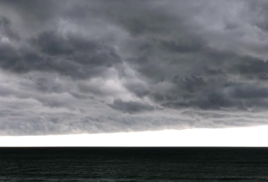 Grey storm clouds over dark ocean water at New Smyrna Beach, Florida