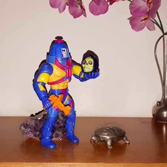 Man-e-Faces holds Skeletor's skull and performs Hamlet