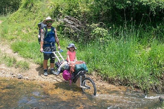 DIY carry buggie being pushed over river with kid on hike with kids
