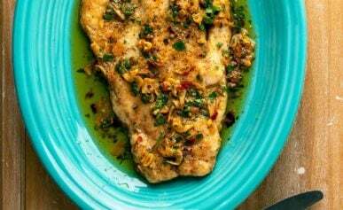 Snook with mojo de ajo garlic sauce on a plate.