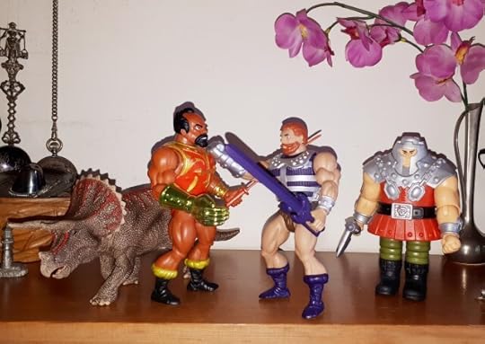 Fisto fights Jitsu, as Ram-Man and a triceratops look on.