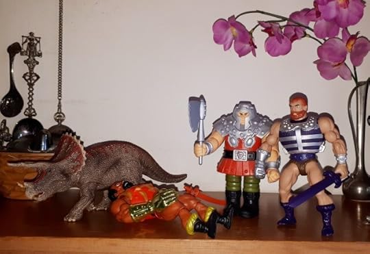 Ram-Man knocked out Jitsu, while Fisto and the triceratops look on.