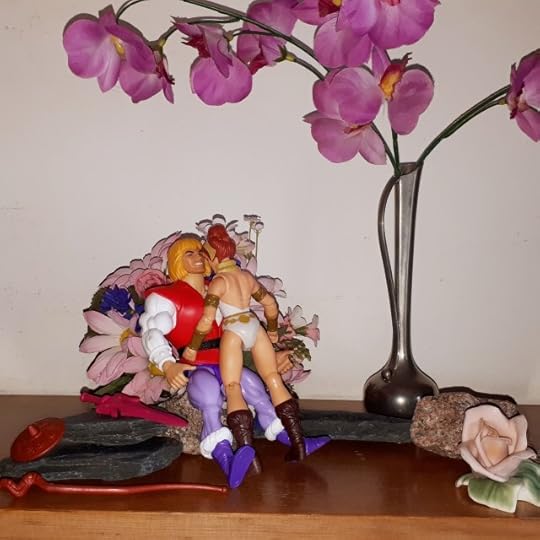 Adam and Teela are kissing in the wilderness.