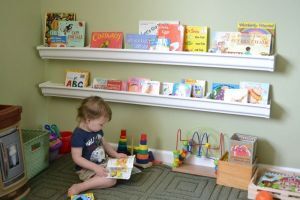A child reading a book in his room.