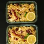 two meal prep containers with lemon orzo salad.