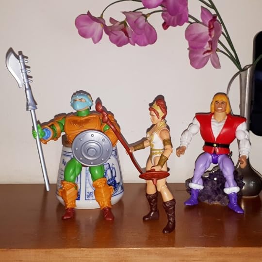 Teela gives orders to a palace guard, while Adam looks on.