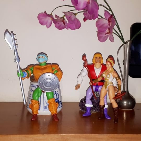 Adam talks with Teela, while the palace guard stands at attention.