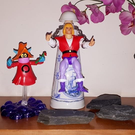 Orko magics up a rose, while Adam is chained up.