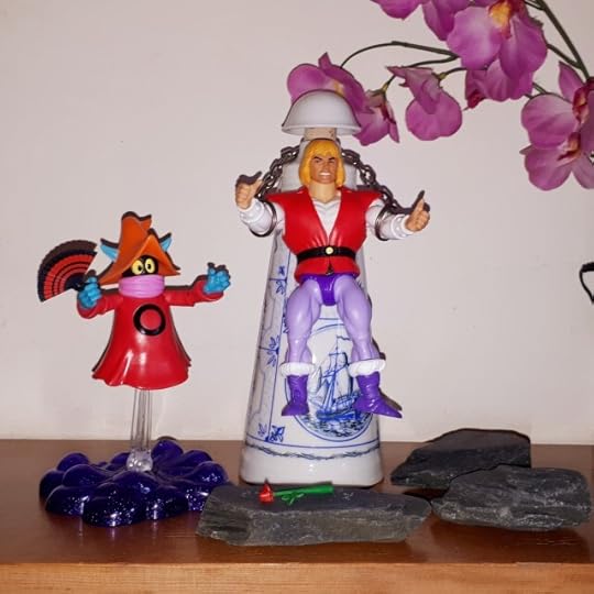 Orko magics up a fan, while a chained Prince Adam wishes he'd hurry up.
