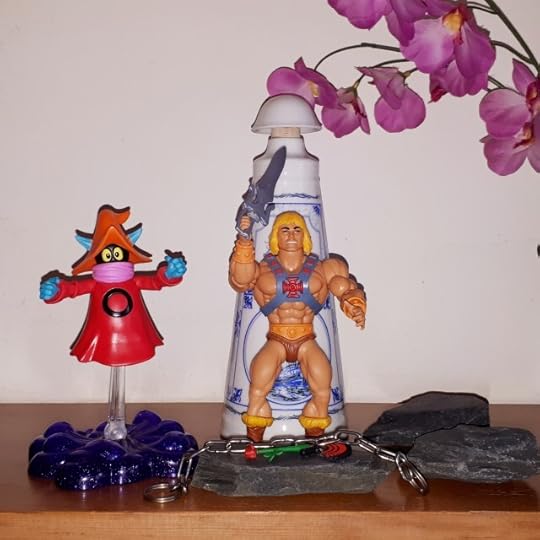 He-Man breaks his chains, as Orko looks on.