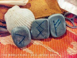 Elder Futhark runes Fehu, Ingwaz, and Kenaz reversed against a white se