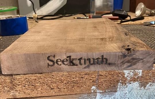 close up of wood burned shelf with text, 