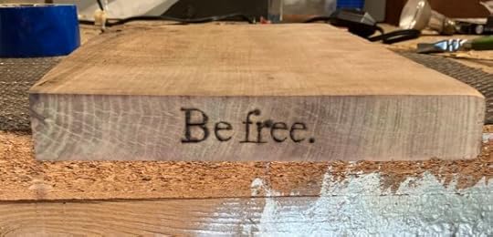 close up of wood burned shelf with text, 