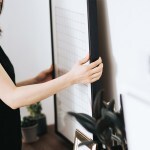 girl hanging picture frame