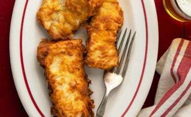 A platter of fried walleye with lemon.