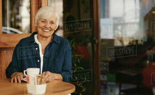 smiling old lady at a coffee shop