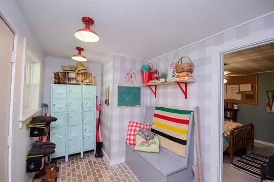 picture of colorful mudroom with mint green lockers, brick floors, and a gray bench