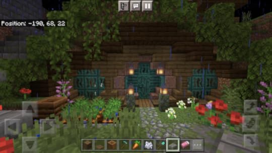 Image of a hobbit hole in Minecraft. Blue doors, brown wood frame, overhanging leaves. I love it so much.