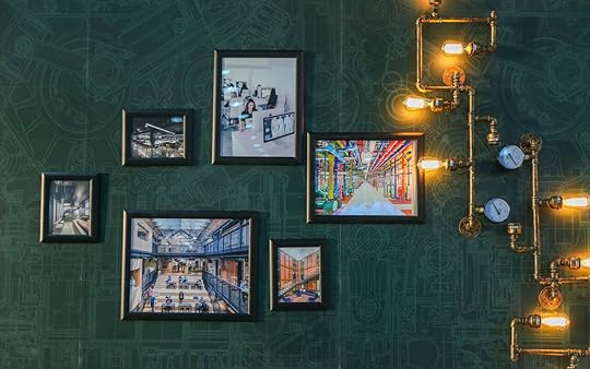 pictures on a green wall with lights
