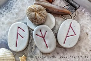 Elder Futhark runes Thurisaz, Algiz, and Ansuz carved into porcelain, with a fossilized sea urchin on a geode slice