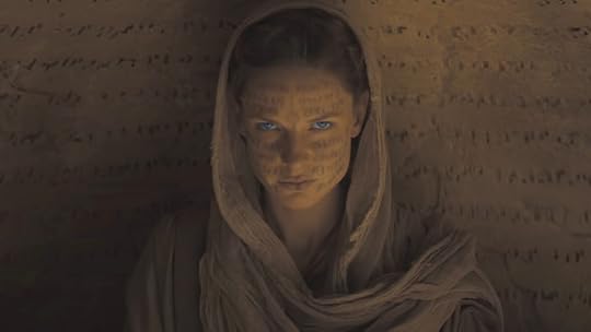 Rebecca Ferguson as Lady Jessica with her hood on looking at the camera in Dune