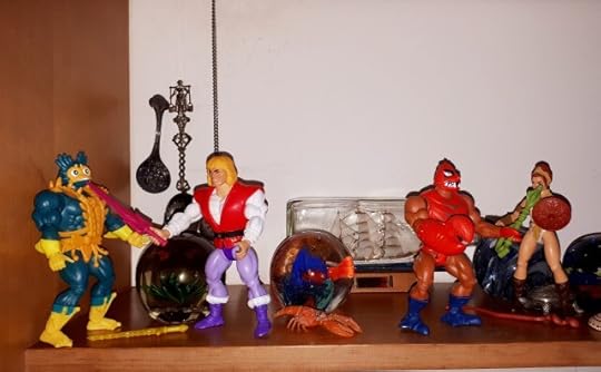 Adam has disarmed Mer-Man, while Clawful is fighting Teela.