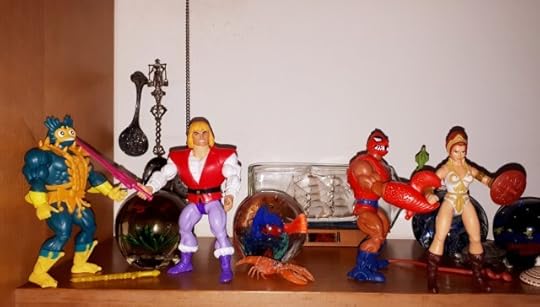 Clawful grabs Teela, while Adam holds Mer-Man at sword point.