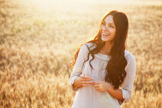 Beautiful brunette lady in wheat field at sunset.