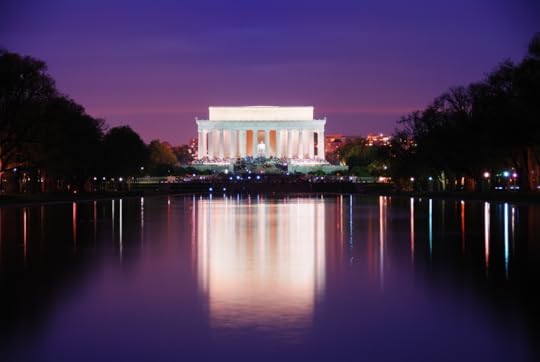 Photo of Lincoln Memorial against a dark purple night sky, illuminated and reflected in the Reflecting Pool on the National Mall in Washington, D.C.