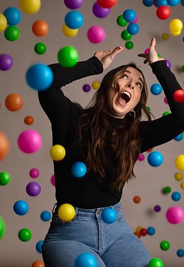 Screaming woman with multi-colored balls falling around her.