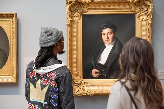Visitors to the Portland Art Museum looking at a painting