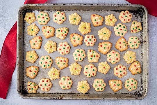 cookie sheet with decorated butter cookies and red ribbon