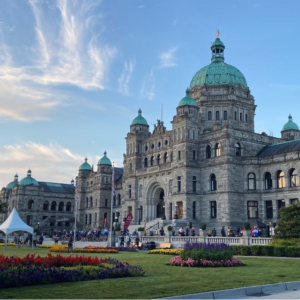 Victoria legislature buildings, early morning blue sky, cyclists lining up at the start line