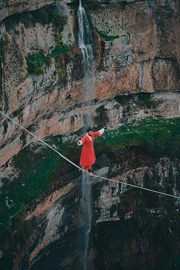 drone shot of a man walking on rope