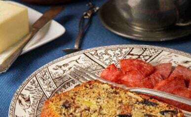 A slice of fig bread on a plate with Taylor ham.