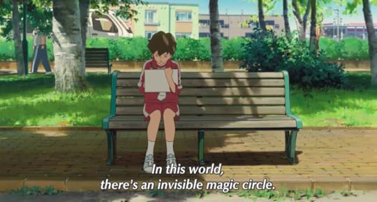 Anna sitting at a park by herself, drawing