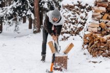 a man splitting firewood with an axe