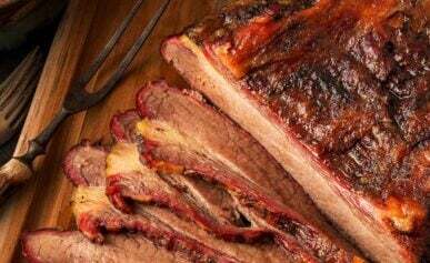 Slices of smoked bison brisket on a cutting board.