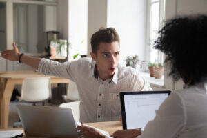 Person being agitated and complaining to a colleague