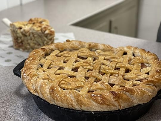 25 pound apple pie on a table with a slice of pie in the background - dollywood food