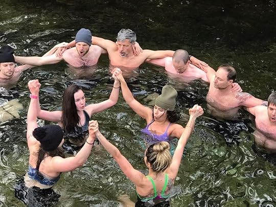 people in water holding hands practicing wim hof method