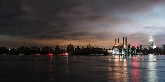 Illuminated Buildings By River Against Sky During Sunset