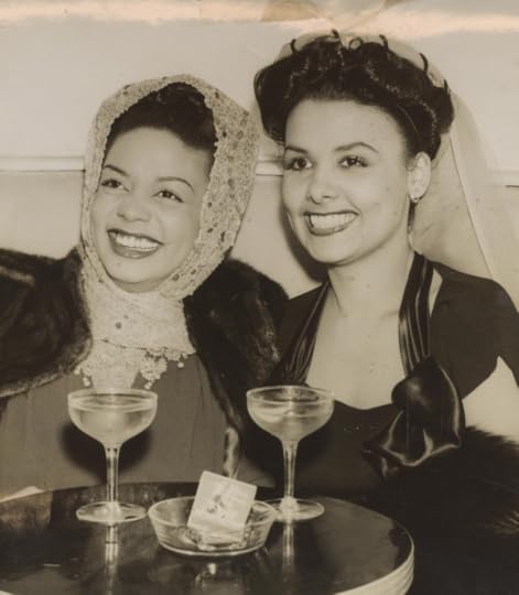 Black and white photo of Hazel Scott and Lena Horne at a club, well-dresssed and sitting at a table