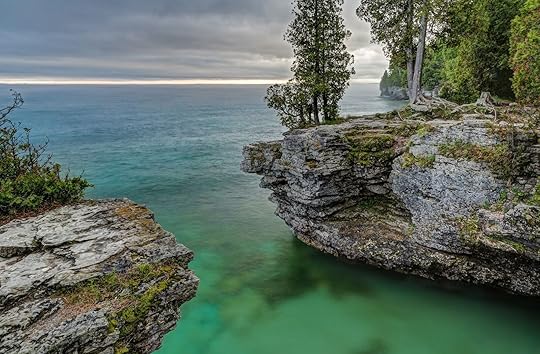 The rocky coast of Door County, Wisconsin's Cave Point displays beautiful colors in the light of a stormy sunrise.