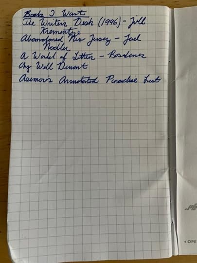 A list of books I want, scribble in cursive in one of my Field Notes notebooks.