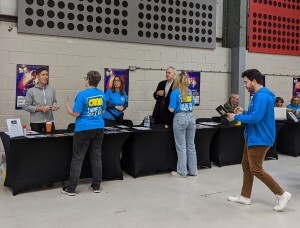 Paul McGahn, Nigel Planer and Chris Barrie sitting at sci fi convention signing tables