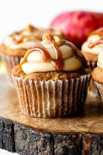 apple cupcake with caramel frosting and salted caramel drizzled on top.