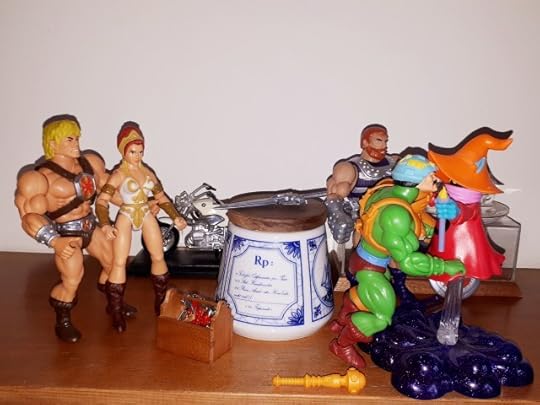 Duncan hugs Orko, while He-Man, Teela and Malcolm look on.