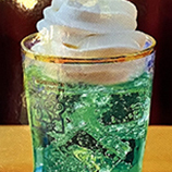 Japanese soda topped with soft serve ice cream melon flavor